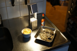 a silver metal lamp standing on a kitchen counter Logo Progressive Present