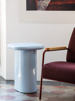 a blue sidetable standing in a room with various other items Logo Progressive Present
