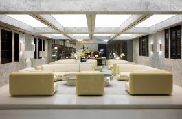 A showroom showing a white couch and various other items Logo Progressive Present