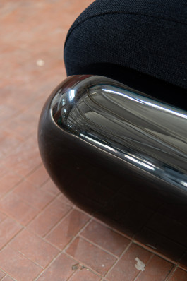 detail shot of a black plastic chair Logo Progressive Present