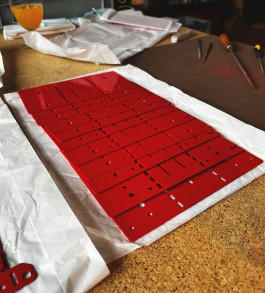 red metal parts of a lamp Logo Progressive Present