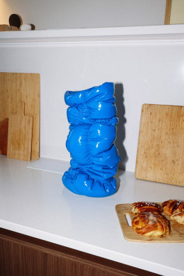 A blue vase standing on a counter Logo Progressive Present