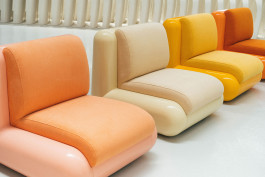 yellow, rose and white chairs standing as a group Logo Progressive Present