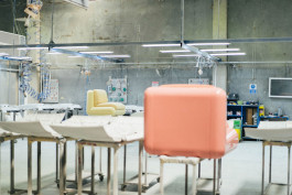 two plastic chairs standing in a workshop Logo Progressive Present