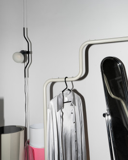 clothing on a silver metal clothes rack Logo Progressive Present