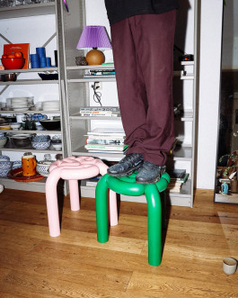 A person with black shoes standing on a green stool Logo Progressive Present