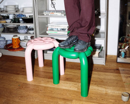 A person with black shoes standing on a green stool Logo Progressive Present