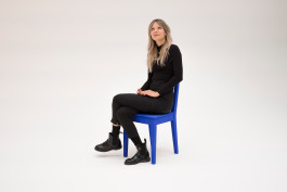 Woman siting on a blue chair Logo Progressive Present