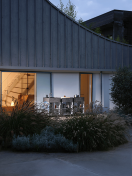 Modular outdoor kitchen setup in front of a modern architectural building at dusk. Logo Progressive Present